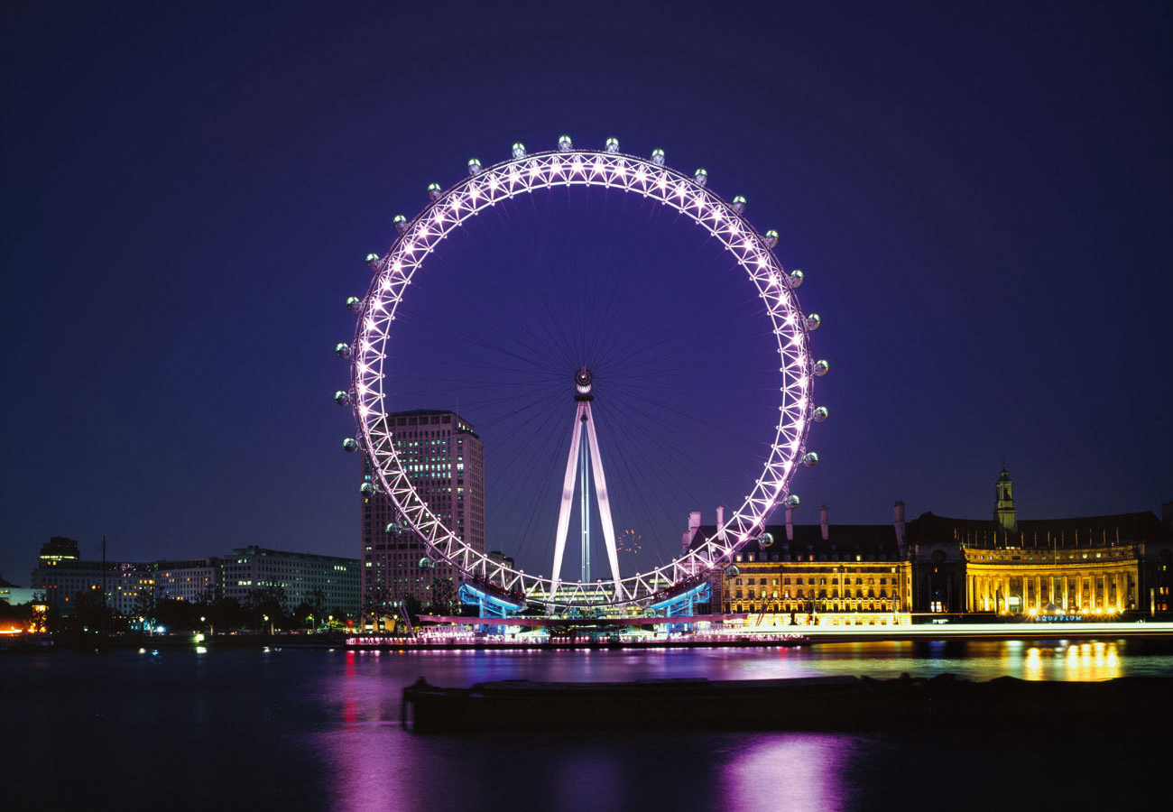 View from Victoria embankment at dusk. The London Eye by Marks Barfield Architects